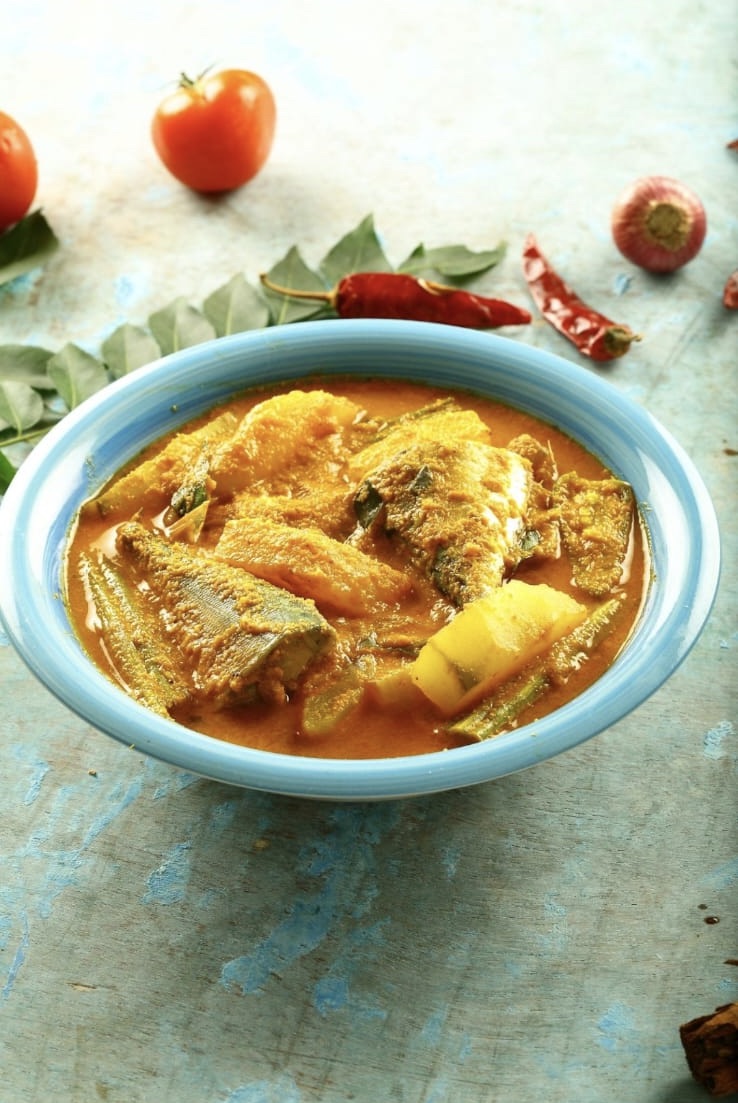 Fish curry served in a blue bowl